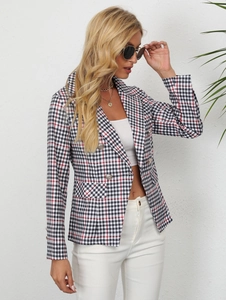 Detail of plaid blazer featuring notched lapels and decorative metallic double-breasted buttons
