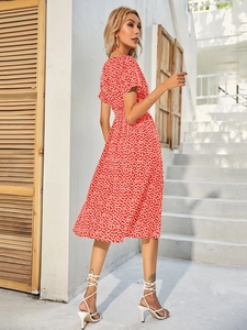 Detail view of red floral summer dress with short sleeves and flattering high waistline
