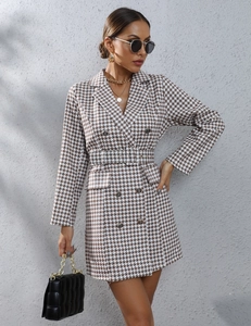 Detailed close-up of houndstooth blazer dress with double-breasted buttons and waist belt