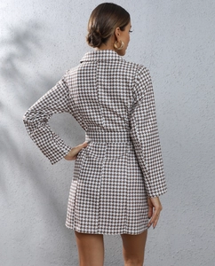 Rear view of a houndstooth blazer dress featuring a waist belt and tailored silhouette