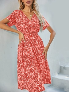 Detail of red floral summer dress with V-neckline, short sleeves and elastic waist