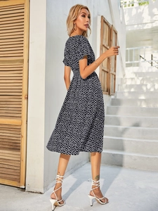 Detailed back view of a black floral midi dress with short sleeves and high waist design