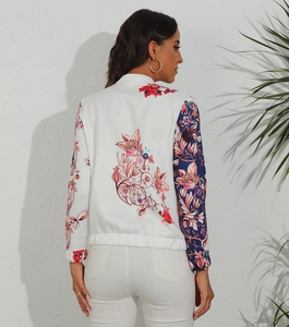 Detail of floral printed bomber jacket back with colorful patterns and elastic hem