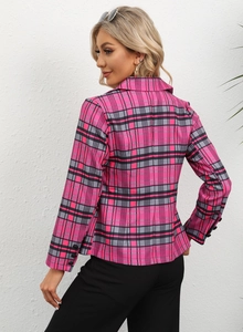 Detail of three black decorative buttons on the sleeve of a pink plaid blazer