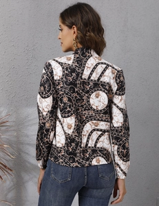 Detailed back view of women's baroque print jacket with gold floral patterns and long sleeves