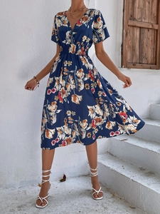 Detailed close-up of V-neck floral midi dress with smocked waist and summer print