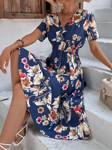 Detail of a deep blue floral midi dress with V-neckline and elastic high waist design