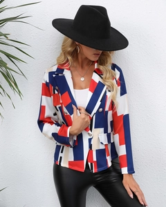 Detail of slim-fit blazer with vibrant geometric patterns and golden metal buttons
