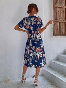 Back view of a navy blue floral midi dress with a cinched waist for summer wear
