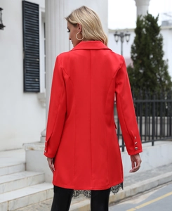 Detail of red blazer with structured back seams and elegant black eyelash lace trim