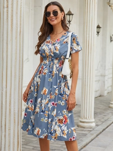 Detail of blue floral dress with V-neck, cinched elastic waist and vibrant flower print