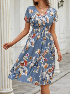 Close-up of blue floral dress with V-neckline and detailed orange flower print