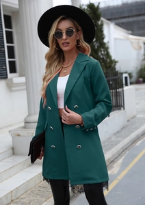 Detail of dark green double-breasted blazer with embossed buttons and lace hem trim