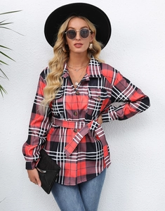 Detail of red and black plaid shirt jacket with adjustable waist belt and front buttons