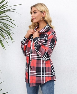 Close-up of red and black plaid long sleeve shirt with front buttons and chest pockets