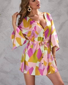 Detailed view of women's summer dress with colorful geometric leaf print and flare sleeves
