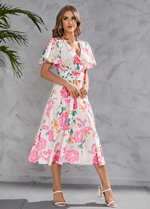 Detailed view of deep V-neck and ruffle sleeves on white floral summer dress