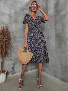 Detailed close-up of dark blue floral maxi dress featuring a V-neckline and elastic waist