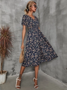 Detail view of navy blue floral dress featuring V-neck and smocked elastic waist design