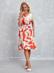 Detail of elegant V-neck dress featuring vibrant colorful wave print and waist tie bow