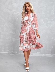 Close-up of paisley print dress with V-neck wrap design and layered ruffle hem details