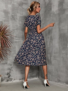 Detailed back view of a navy blue floral midi dress with a flattering cinched waistline
