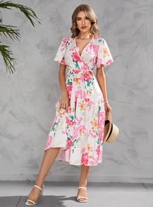 Detailed view of wrap V-neckline and waist tie on white floral summer midi dress