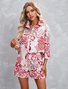 Detail view of women's two-piece casual set featuring red abstract print and button-up shirt