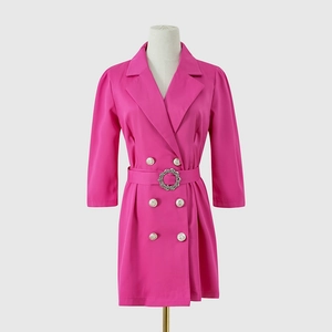 Detail of rose pink blazer dress featuring silver buttons and rhinestone buckle belt