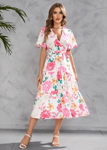 Close-up of V-neck summer floral dress with ruffle sleeves and tiered skirt detail
