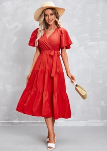 Detail of red V-neck tiered dress with ruffled sleeves and adjustable waist tie belt