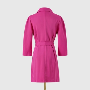 Detail of a magenta mini dress with three-quarter sleeves and matching waist belt