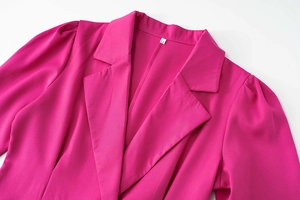 Detail of peaked lapel and puff sleeves on a rose pink women blazer dress
