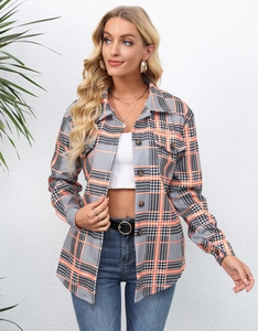 Detail of wooden buttons and chest pockets on long sleeve plaid shacket for women