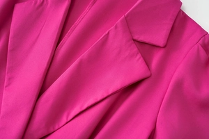 Detail of notch lapel with precise stitching on magenta pink blazer for women