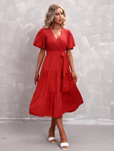 Detail of red tiered V-neck dress featuring flutter sleeves and a waist tie-bow