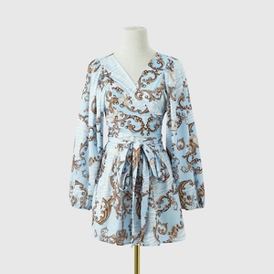 Detail of V-neck wrap top with baroque floral print and decorative waist bow