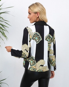 Detail of elegant black and white striped blazer with golden vintage feather pattern