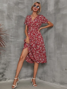 Detail view of red floral summer dress featuring a V-neckline and high waist design