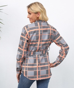 Detail of autumn houndstooth plaid shirt with waist belt and button closure