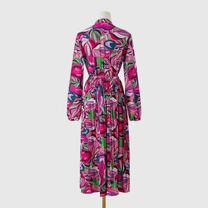 Détail de l'ourlet plissé et de l'imprimé abstrait sur cette robe midi à manches