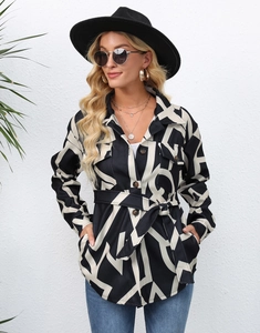 Detail of long sleeve printed jacket featuring black and white geometric abstract patterns