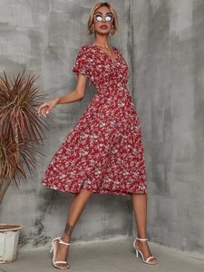 Detail of red floral midi dress with V-neckline and elastic waist in a garden style