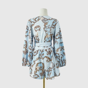 Detailed back view of women's long sleeve floral romper with baroque pattern on mannequin