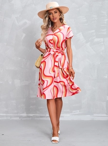 Detailed view of women's summer V-neck dress with colorful wave print and waist tie