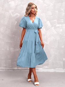 Detail of light blue tiered dress featuring V-neckline and ruffled short sleeves