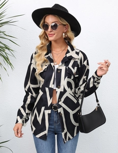 Detail of loose-fit black and white letter print jacket with front pockets and buttons