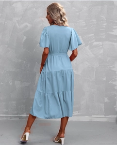 Detail of light blue tiered dress featuring layered skirt and ruffled short sleeves