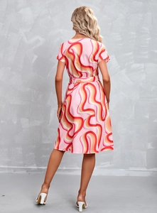 Back view of a short-sleeved dress with pink and orange wave prints and waist belt