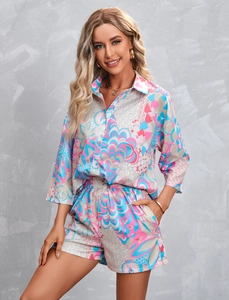Detail of summer two-piece set featuring abstract geometric print and button-up shirt
